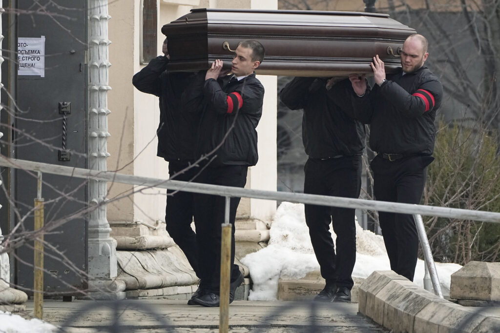 Workers carry the coffin of Russian opposition leader Alexei Navalny to the Church of the Icon of the Mother of God Soothe My Sorrows, in Moscow, Russia, Friday, March 1, 2024. Relatives and supporters of Alexei Navalny are bidding farewell to the opposition leader at a funeral in southeastern Moscow, following a battle with authorities over the release of his body after his still-unexplained death in an Arctic penal colony. (AP Photo)