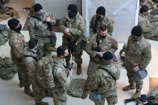 Hundreds of National Guard troops hold inside the Capitol Visitor's Center to reinforce security at the Capitol in Washington, Wednesday, Jan. 13, 2021. The House of Representatives is pursuing an article of impeachment against President Donald Trump for his role in inciting an angry mob to storm the Capitol last week. (AP Photo/J. Scott Applewhite)